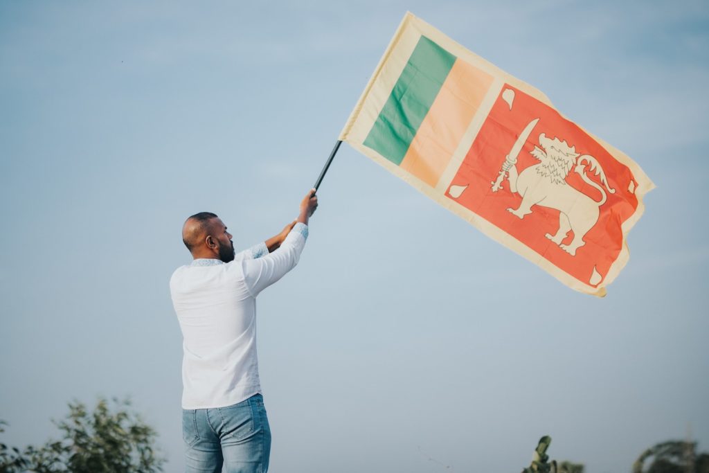 A Man Waving the Sri Lanka National Flag